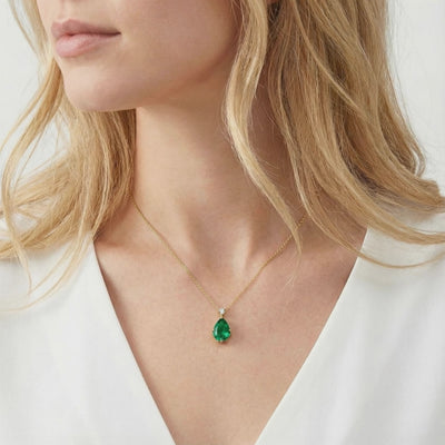 Solid gold necklace with pear-cut simulated emerald.