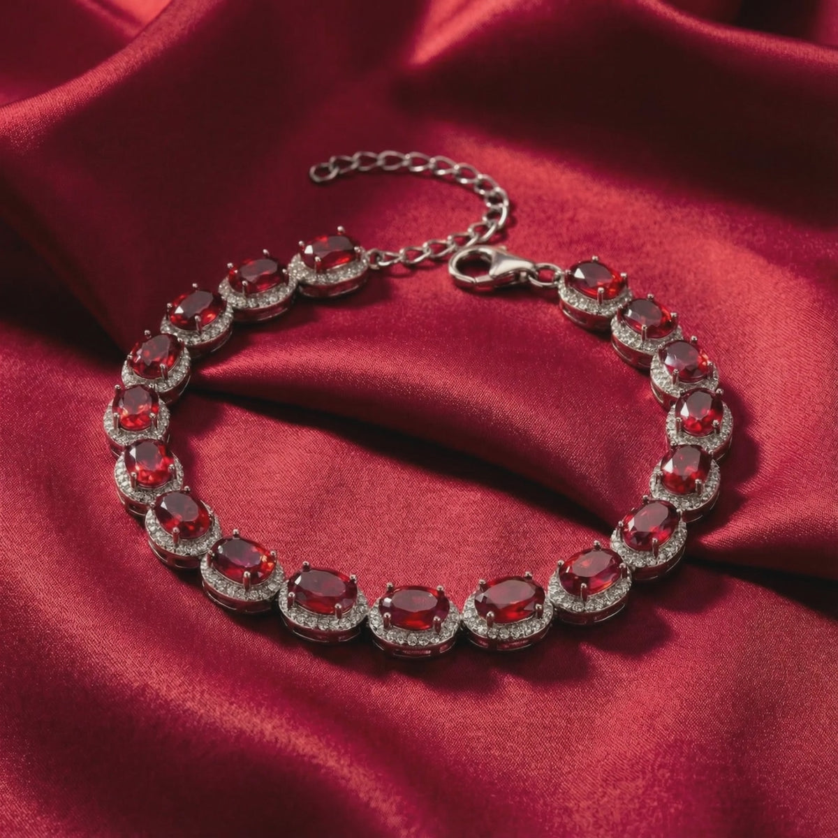 Solid gold tennis bracelet with simulated rubies.