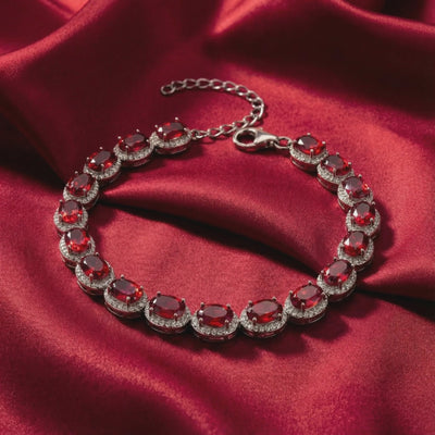 Solid gold tennis bracelet with simulated rubies.