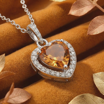Solid gold necklace featuring a heart-cut simulated topaz pendant.