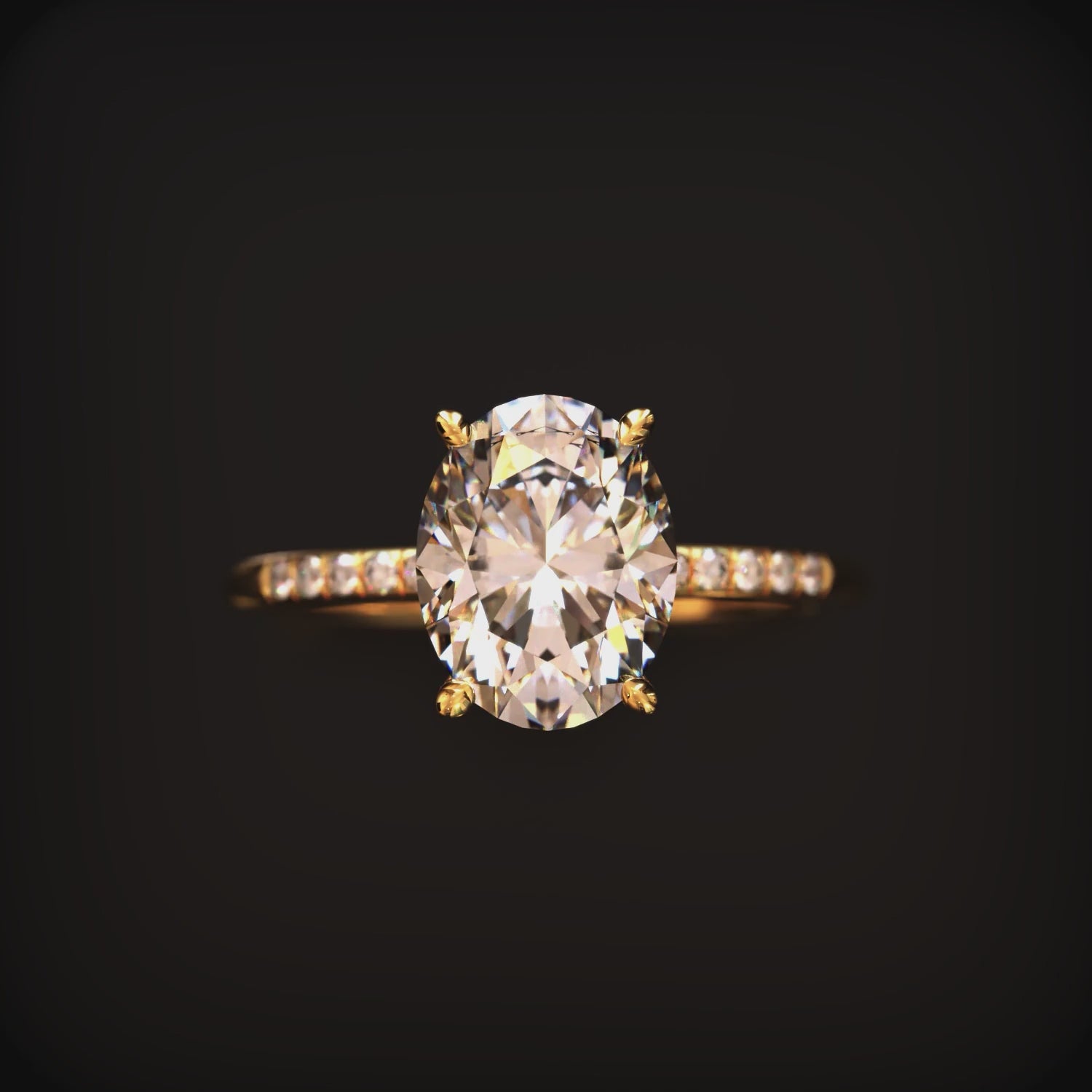 An oval moissanite ring in solid gold with a pavé band.