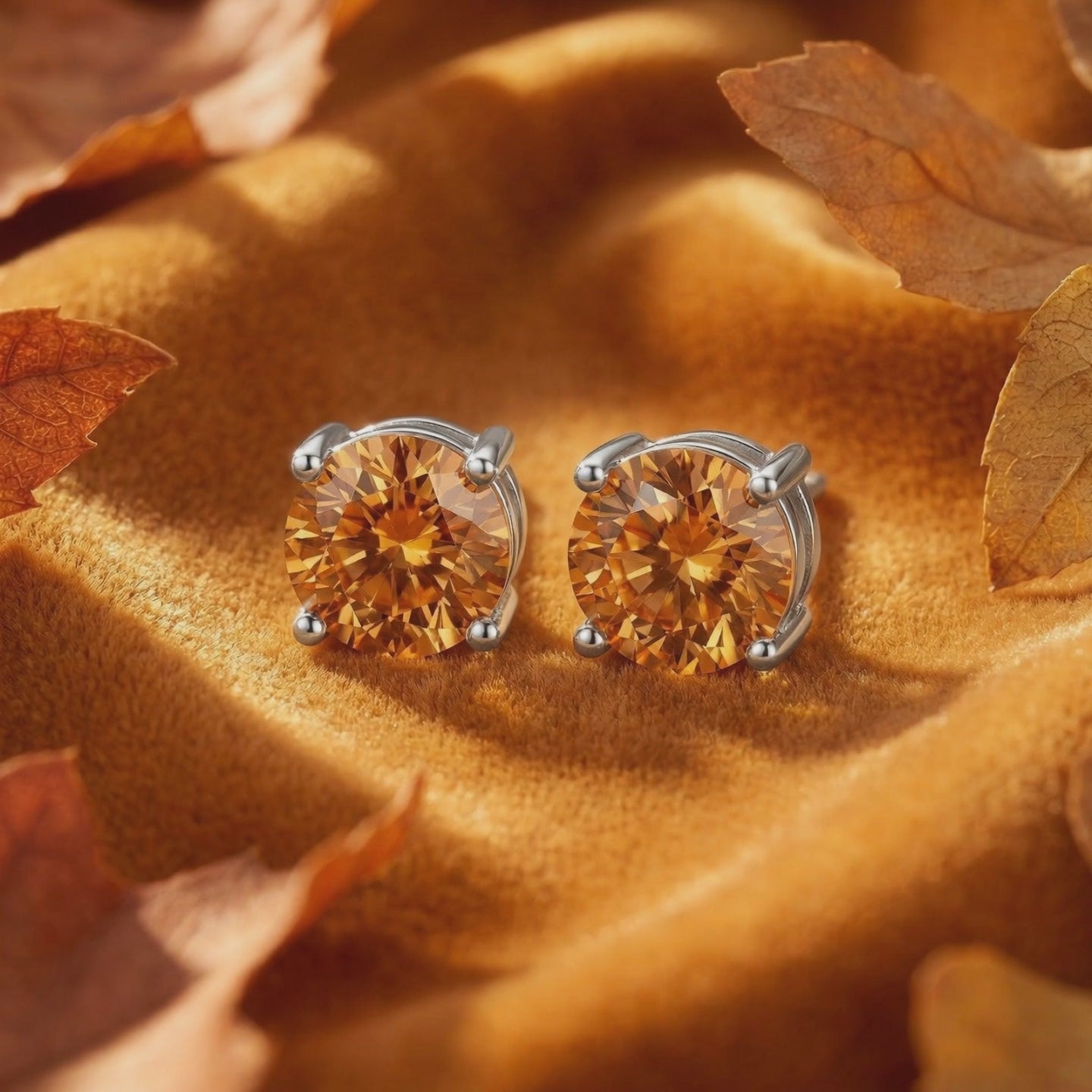A pair of solid gold stud earrings with simulated topaz.