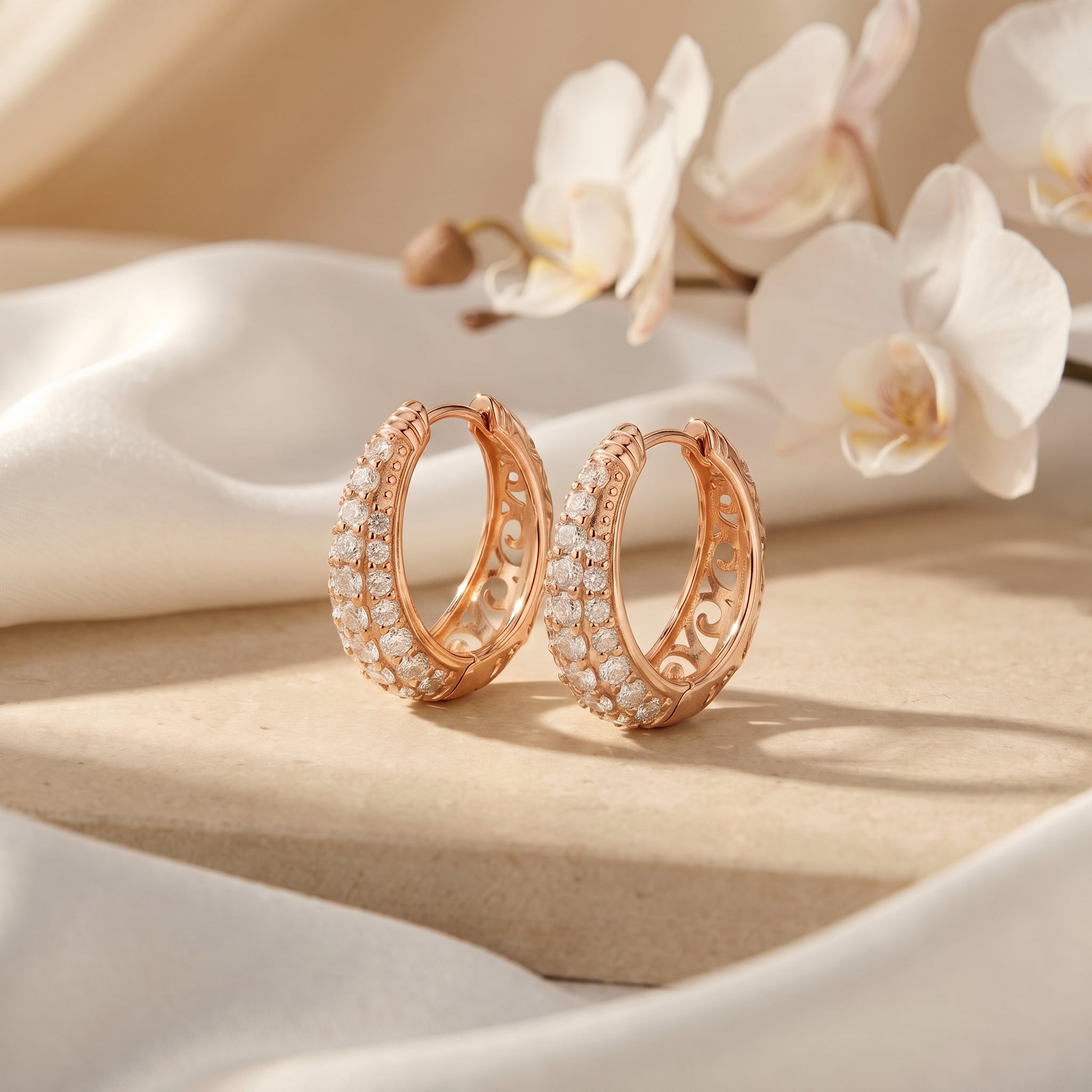 The Corabelle moissanite J-hoop earrings in solid rose gold.