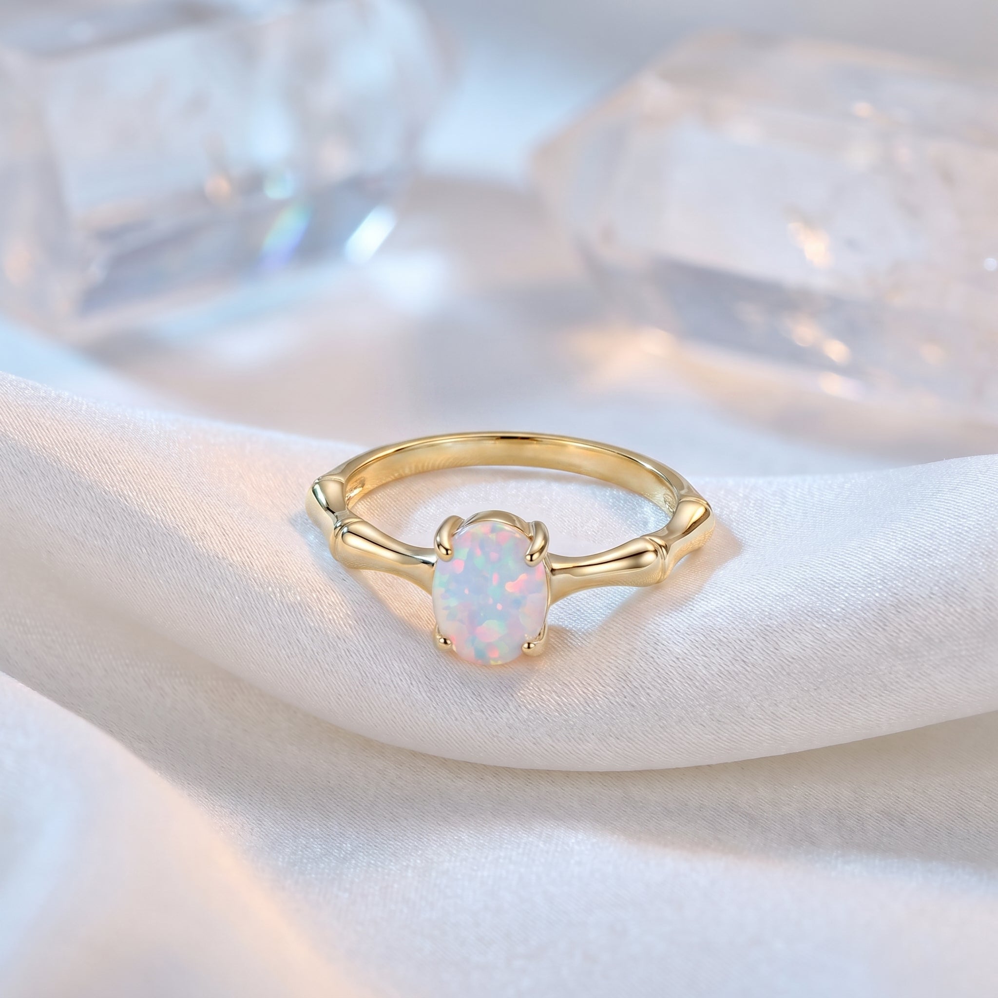 The Guinevere oval natural opal ring in solid yellow gold.
