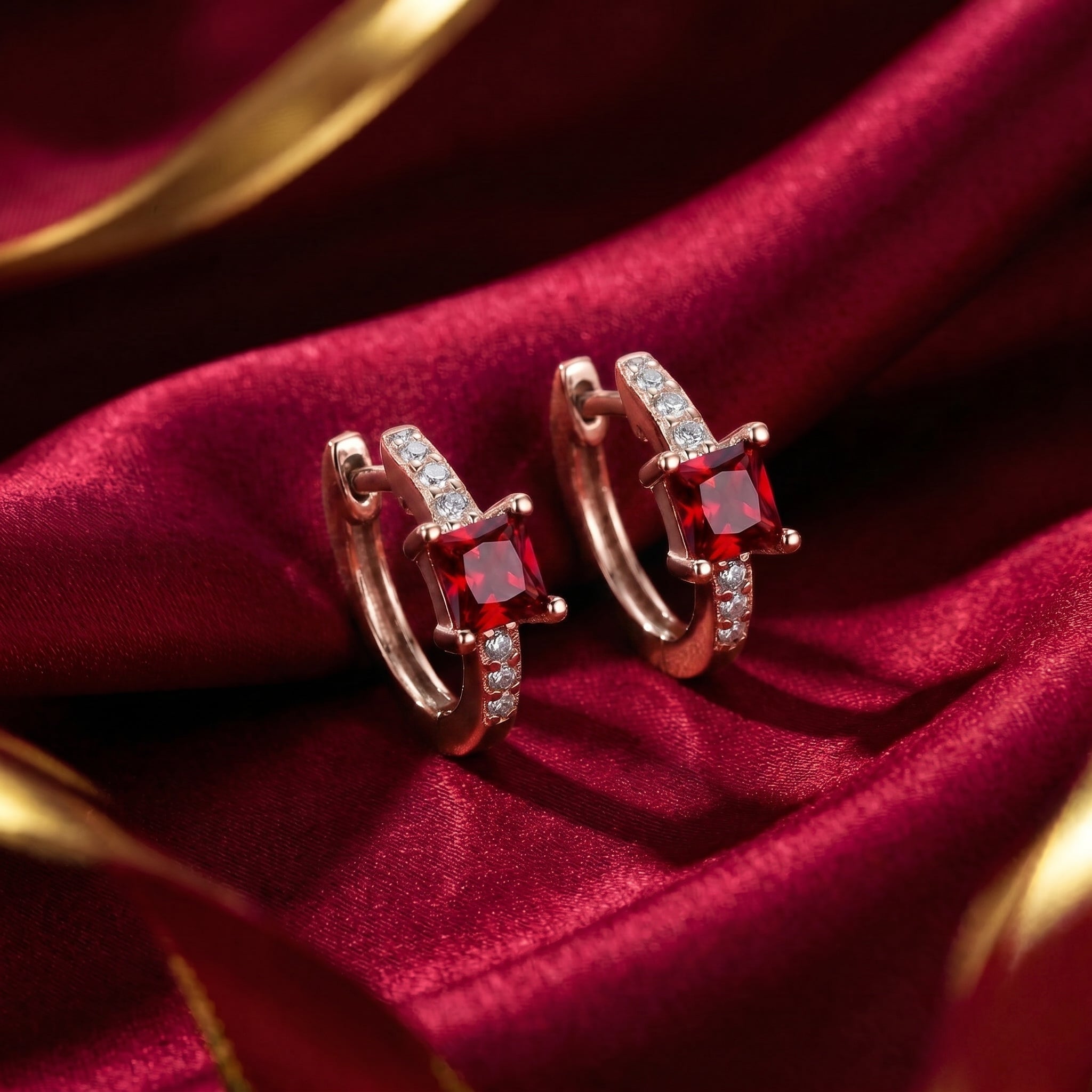Square huggie earrings with simulated rubies in solid rose gold.