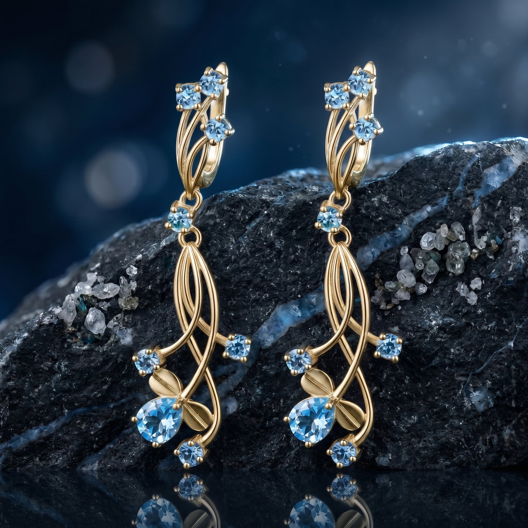 The Oceanis Cascade natural blue topaz drop earrings in solid yellow gold.